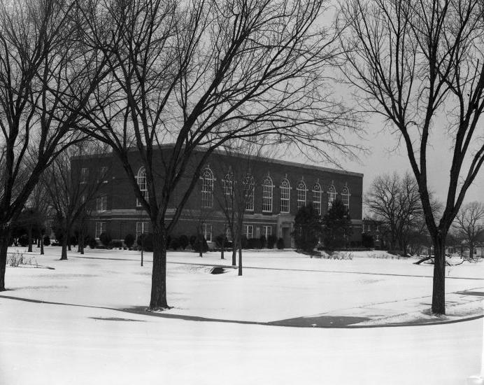 A black and white photograph of David Talbot Hall, a brick building with windows on all sides.